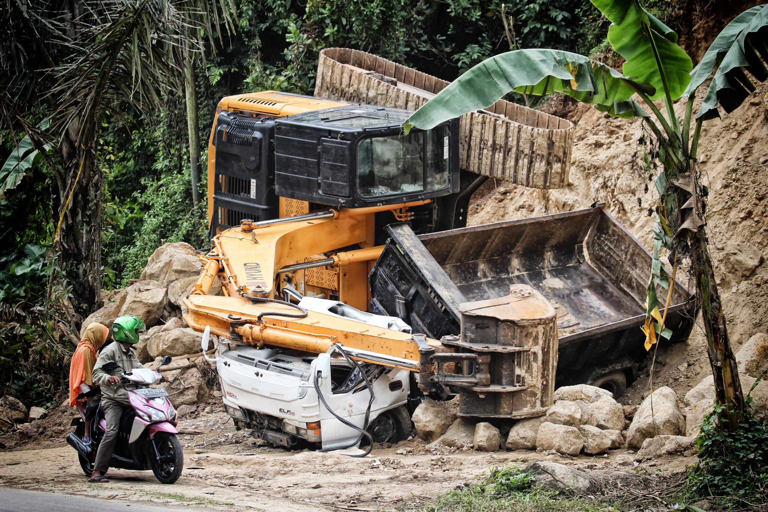 two people riding motorcycle two people riding motorcycle looking at the excavator accident