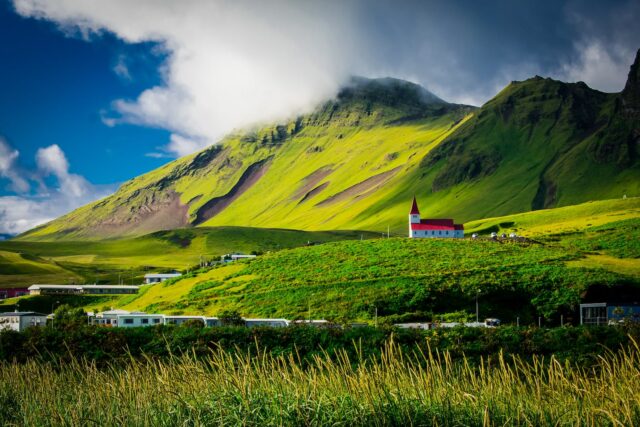 Photo by Rudy Kirchner Green Field Near Mountain During Daytime