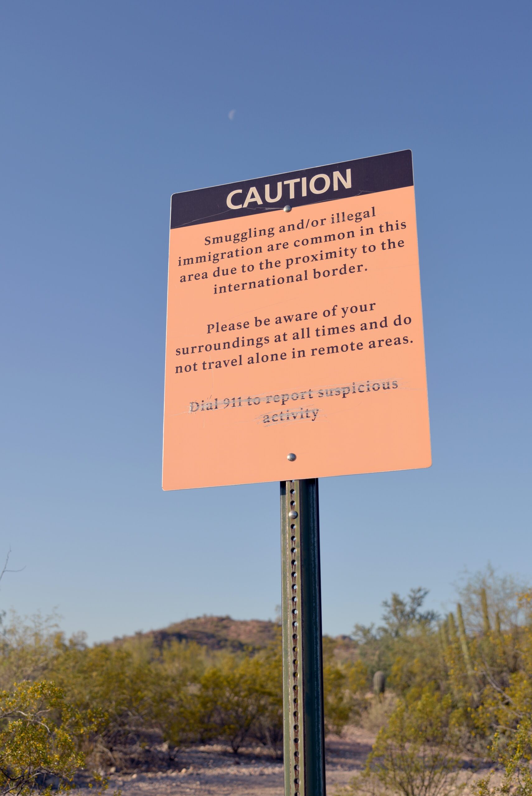 a caution sign in a caution sign in the middle of a desert