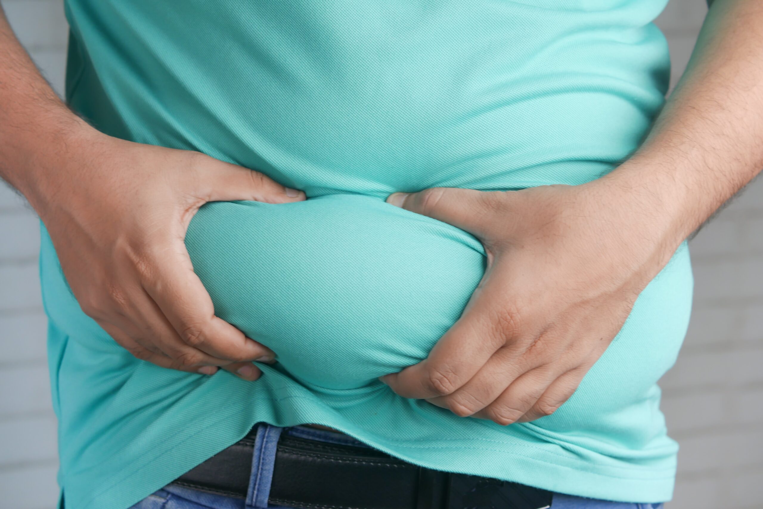 a man holding his a man holding his stomach with his hands