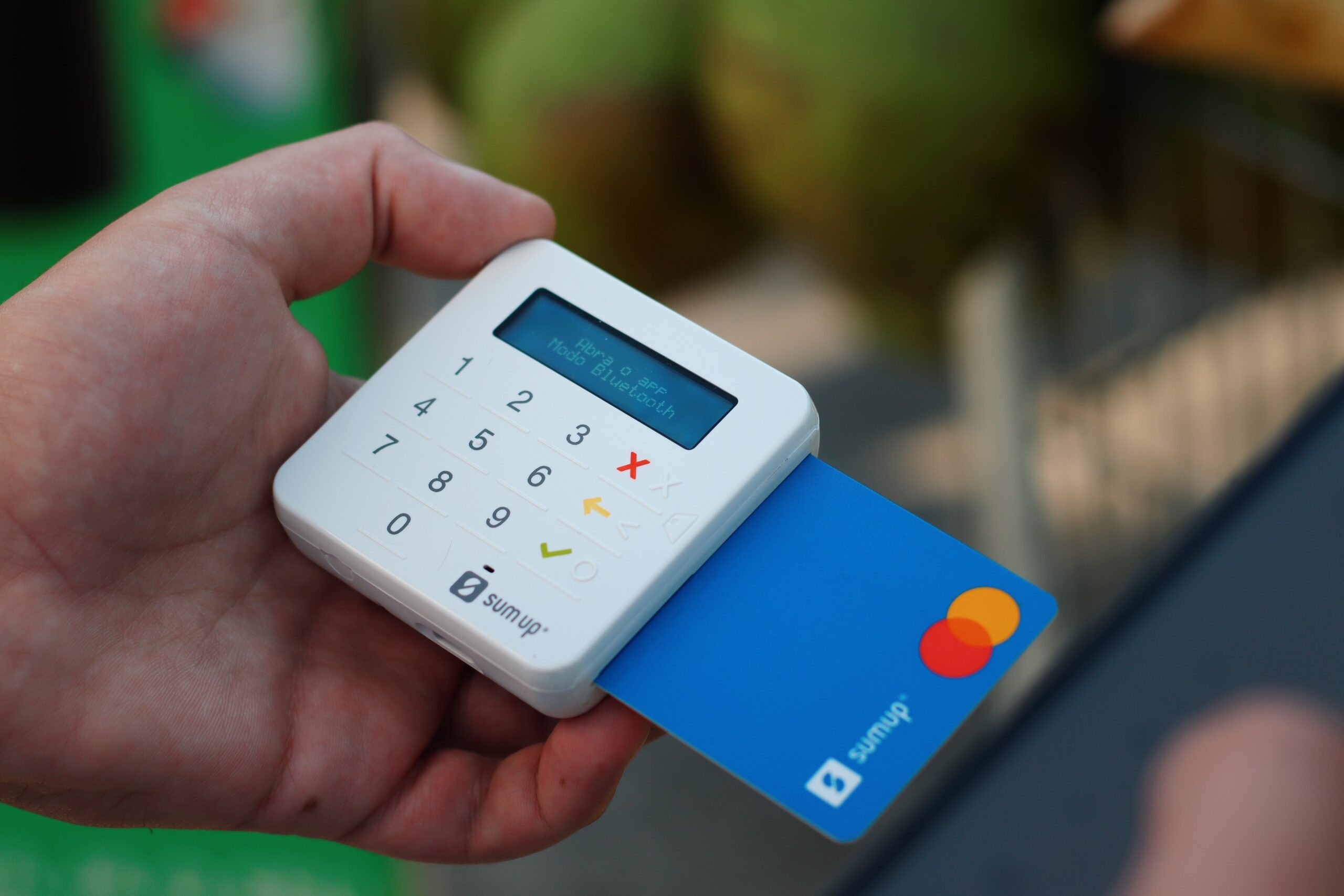 a person holding a a person holding a credit card and a cell phone