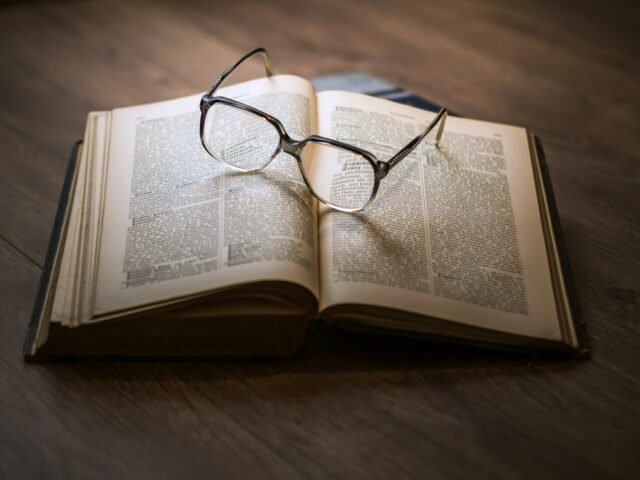 Photo by Dariusz Sankowski framed eyeglasses on top open book