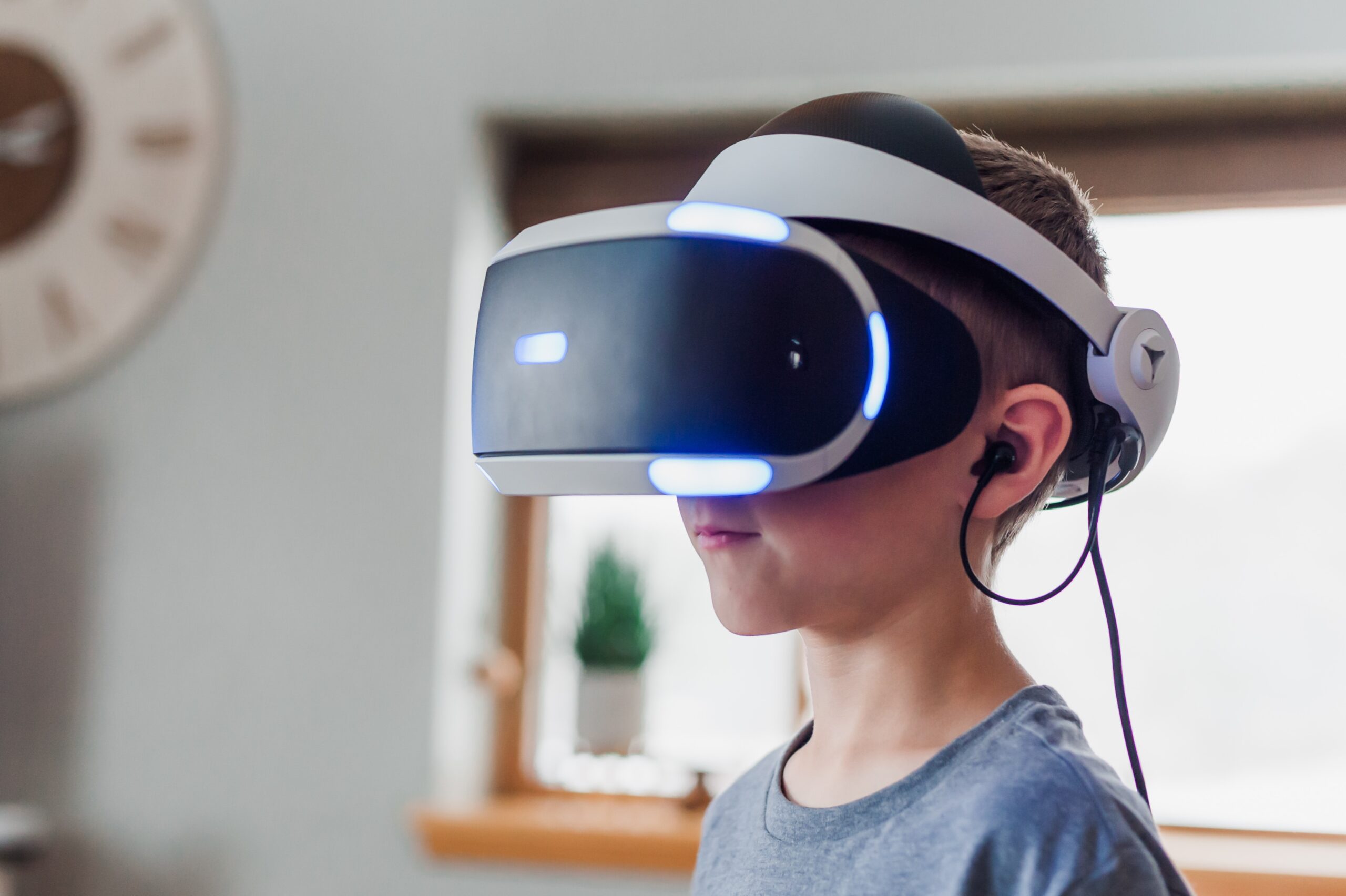 boy wearing black and boy wearing black and white VR headset