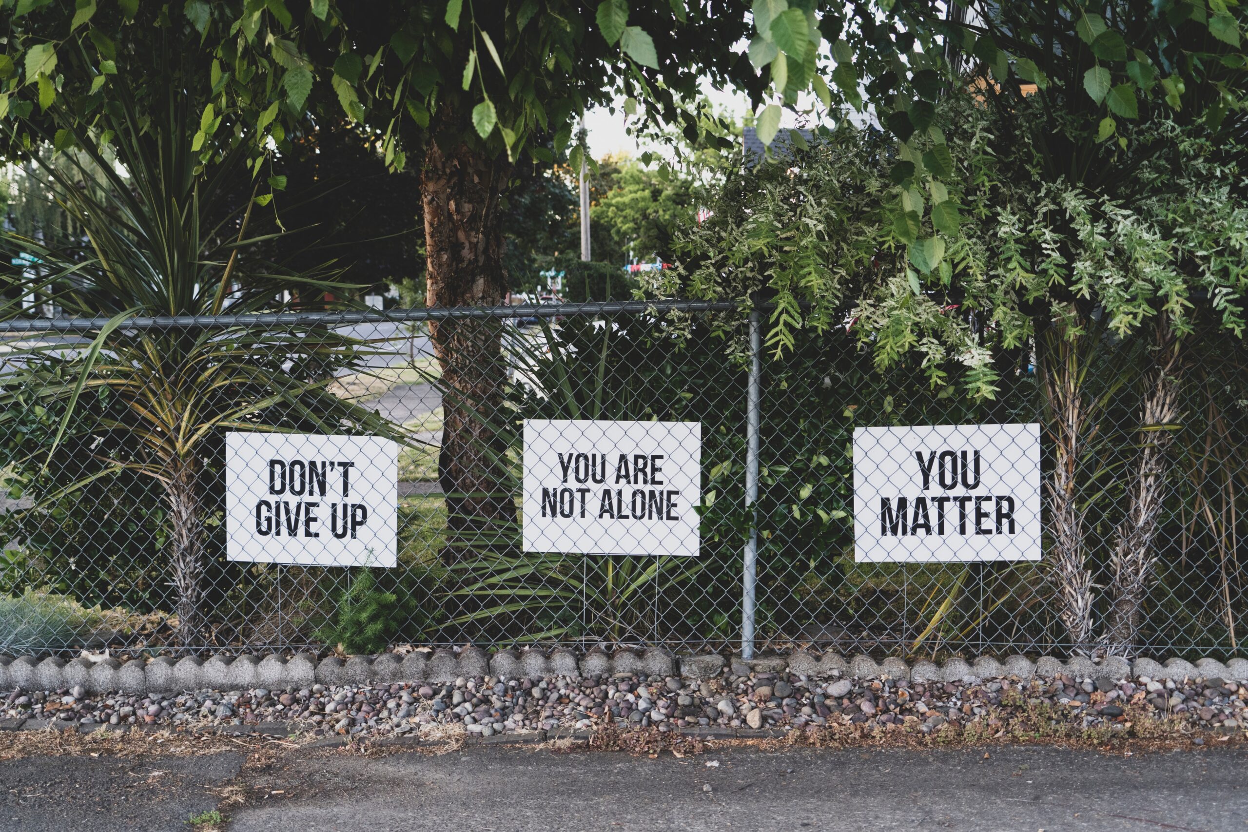 don't give up. you don't give up. You are not alone, you matter signage on metal fence