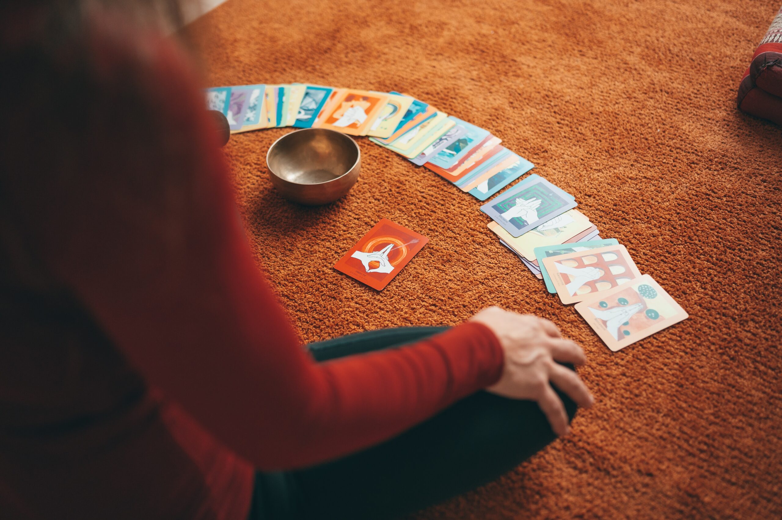 person in red long person in red long sleeve shirt holding playing cards
