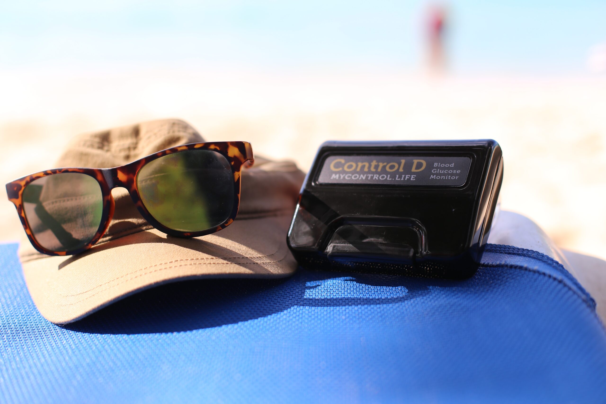 tortoiseshell framed sunglasses near tortoiseshell framed sunglasses near black Control D device taken at daytime