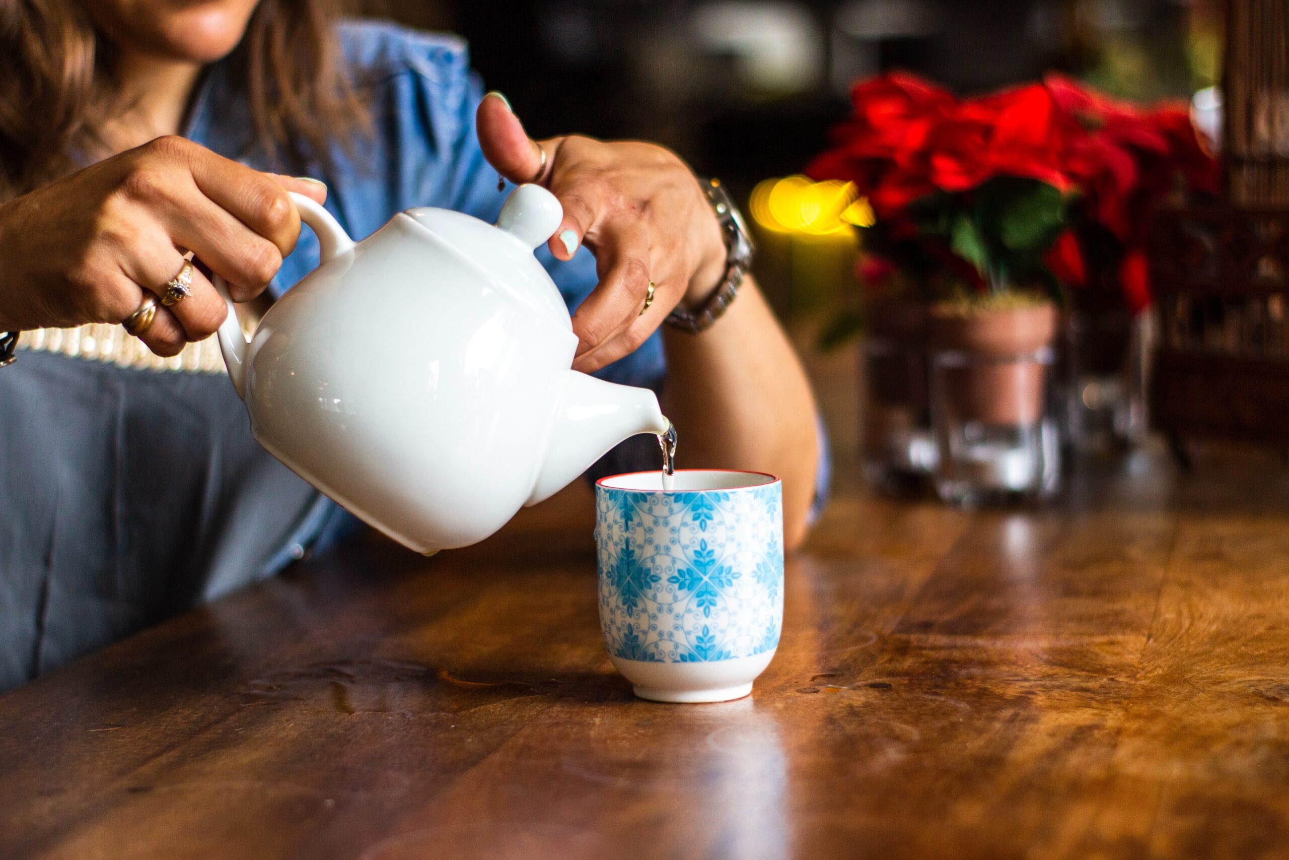 unknown person holding white unknown person holding white ceramic kettle