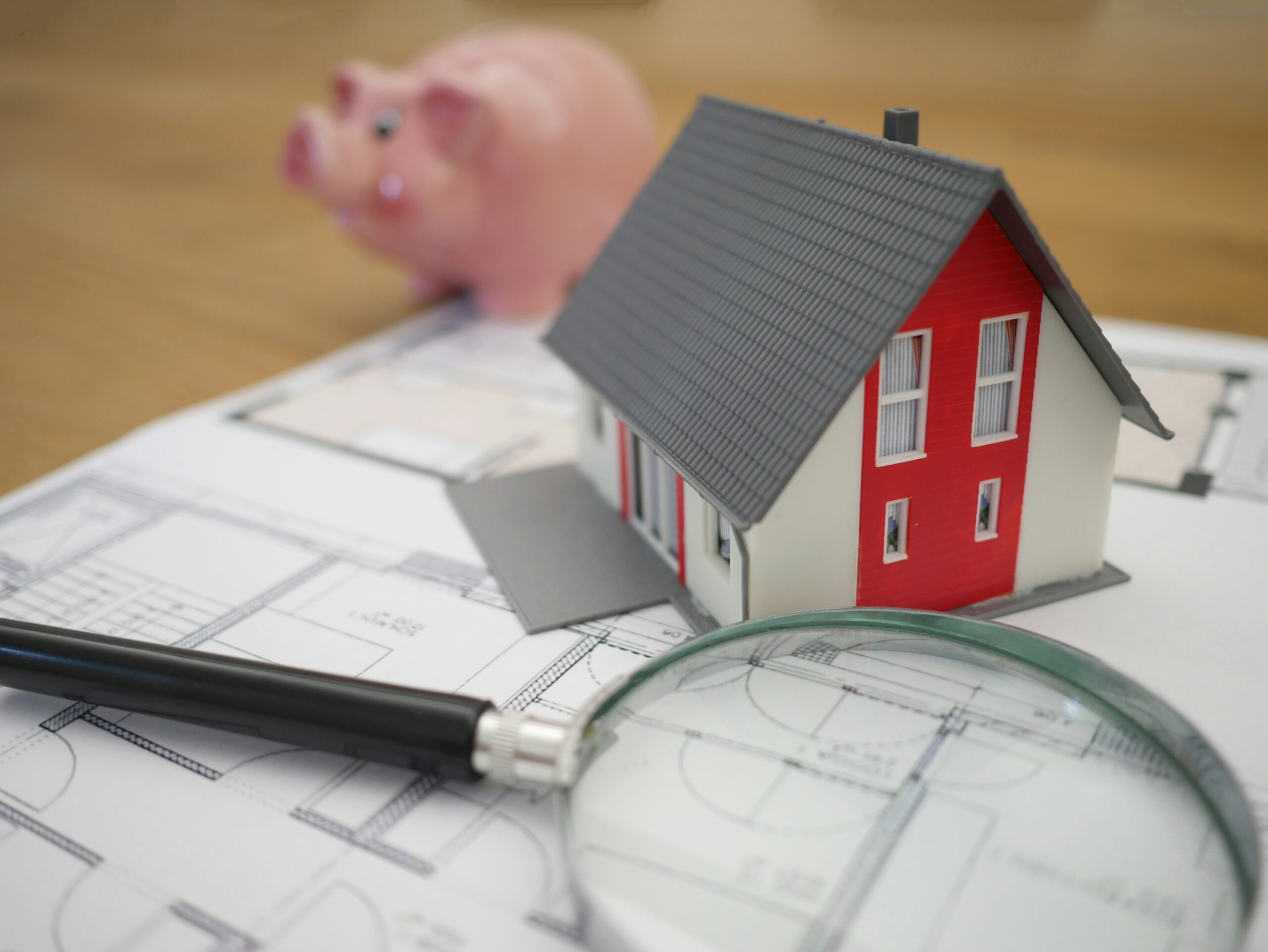 white and red wooden white and red wooden house beside grey framed magnifying glass